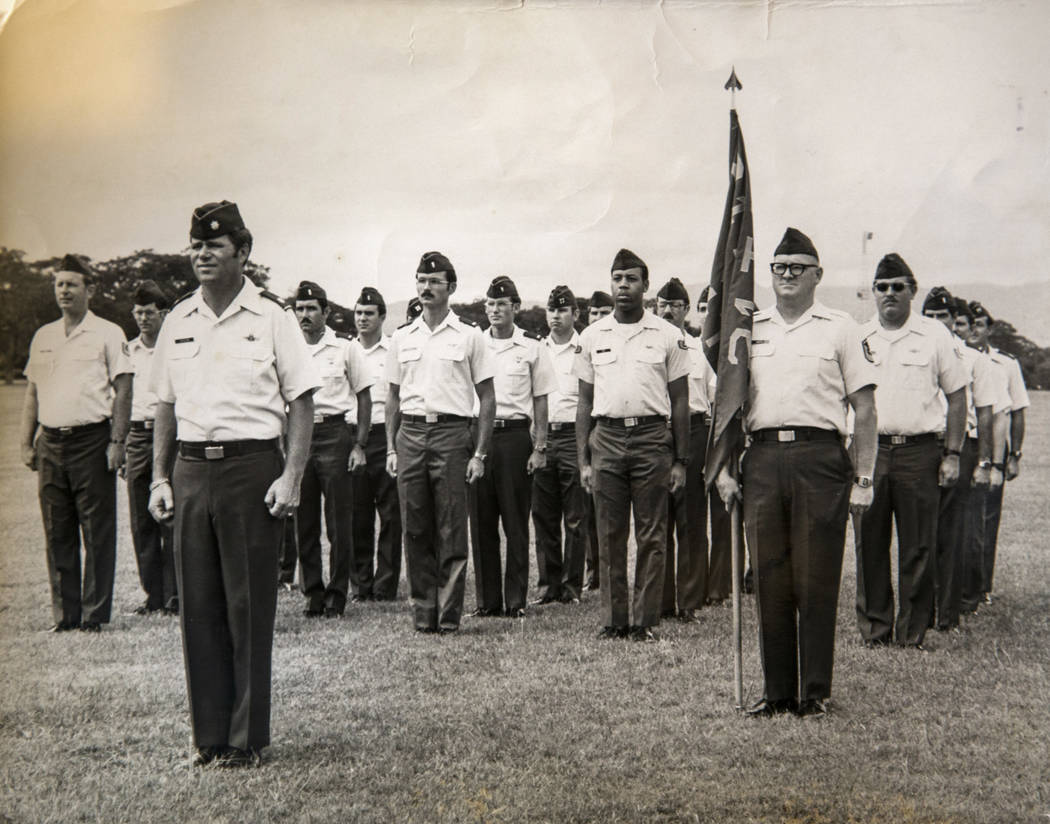 This 1983 photo shows Clifford Smith holding a flag during a Change of Command ceremony. The Sm ...