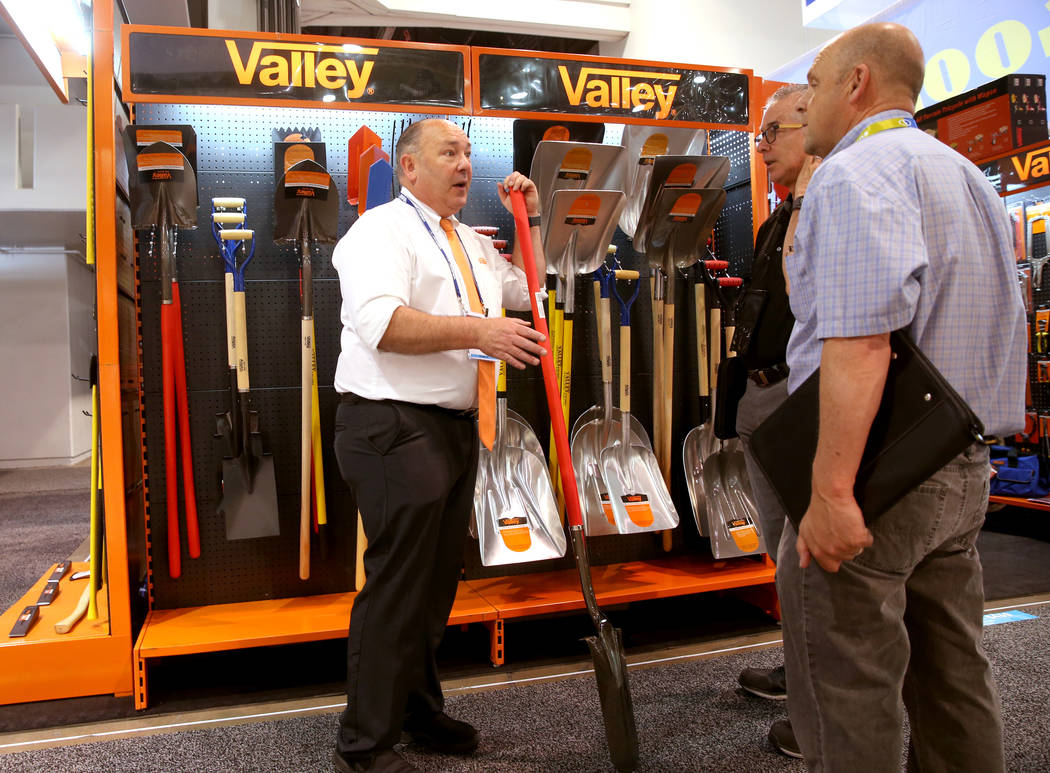 Frank Mondelo, of Paramount, California, shows tools to Walter Harris, center, and Mark Girot o ...