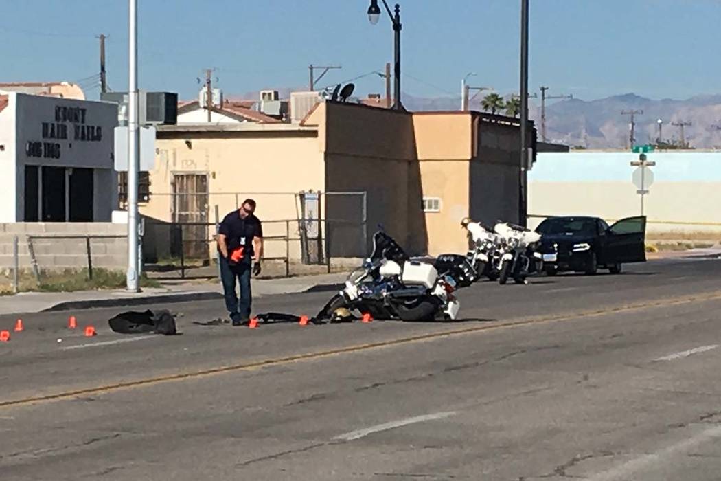 A Las Vegas motorcycle officer suffered minor injuries when a driver he had stopped for a traff ...