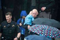 A parent leaves the recreation center where students were reunited with their parents after a s ...