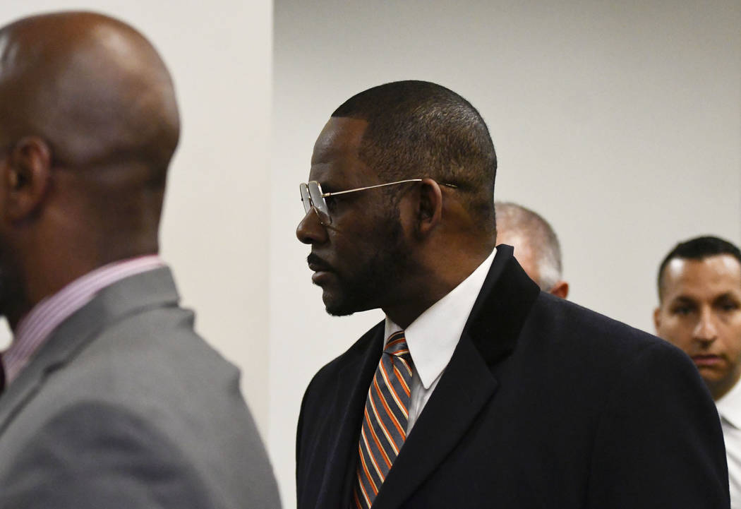 Musician R. Kelly arrives at the Daley Center for a hearing in his child support case on Wednes ...