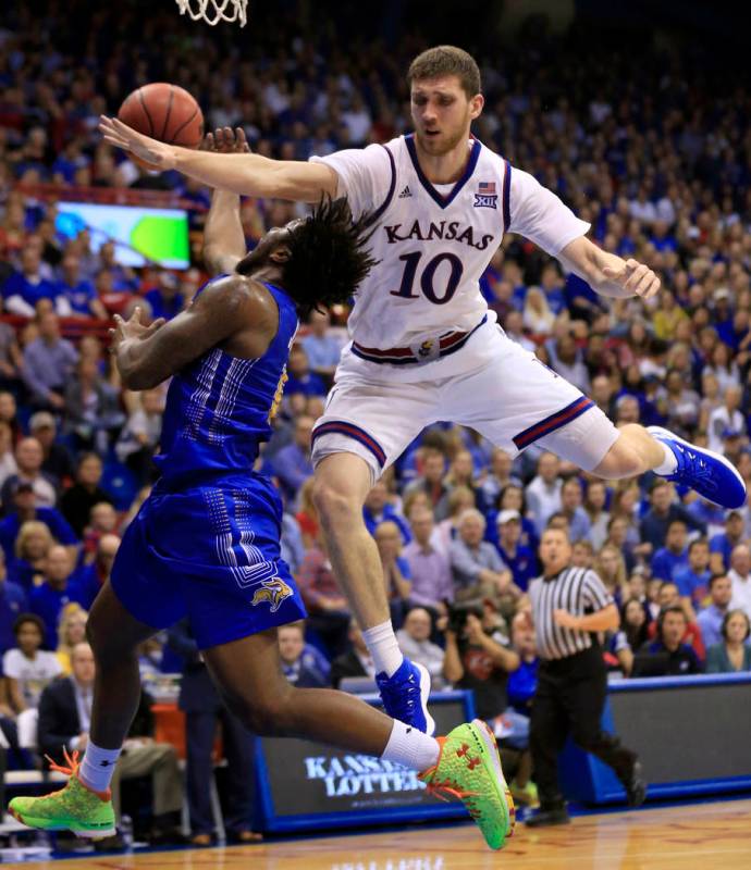 South Dakota State guard David Jenkins Jr. (5) is fouled by Kansas guard Sviatoslav Mykhailiuk ...