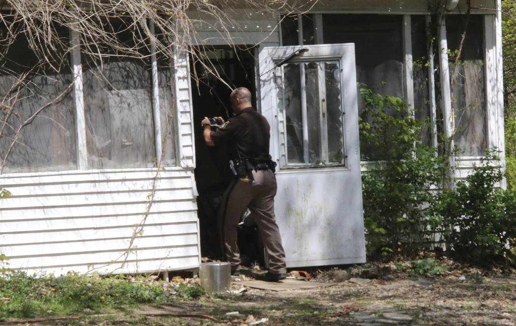 In this Monday, May 6, 2019 photo, a St. Joseph County Sheriff deputy photographs the site wher ...