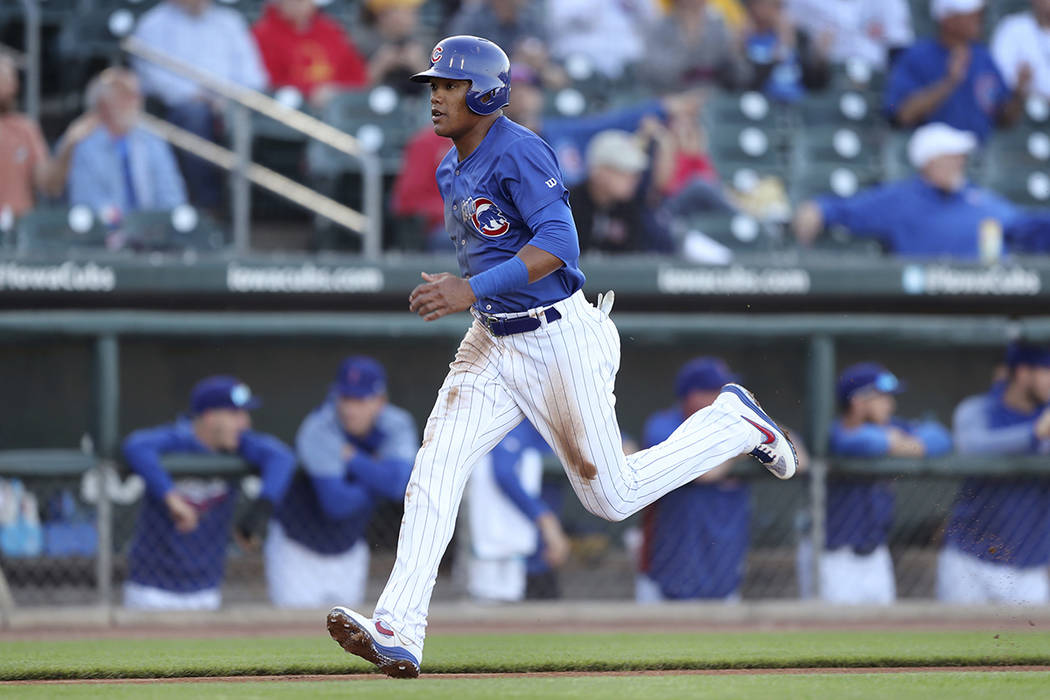 Iowa Cubs shortstop Addison Russell scores a run during a Triple-A baseball game against the Na ...