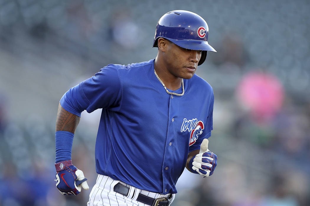 Iowa Cubs shortstop Addison Russell runs to first base during a Triple-A baseball game against ...
