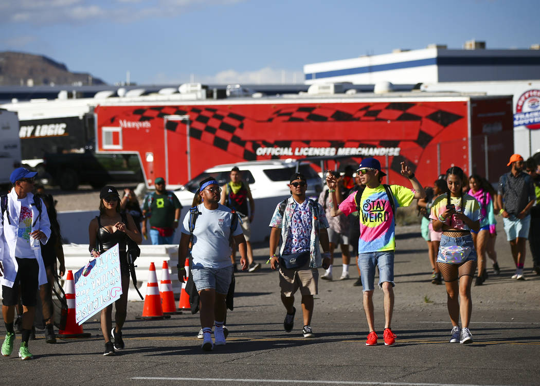 Electric Daisy Carnival attendees make their way to the Las Vegas Motor Speedway in Las Vegas o ...