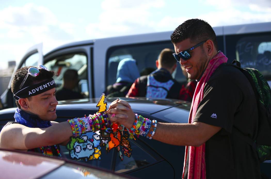 Alex Spry, of Moreno Valley, Calif., left, trades kandi with Esteban Hernandez, of N. J., as El ...