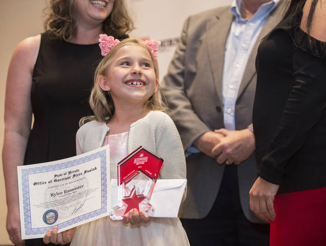 Award winner Rylee Bannister, left, a second grader from Staton Elementary School, smiles at th ...