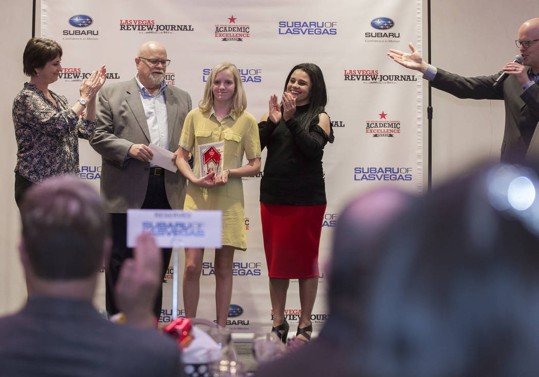 Award winner Emma Rae Scheidler, third from left, a seventh grader at Las Vegas Day School, pos ...