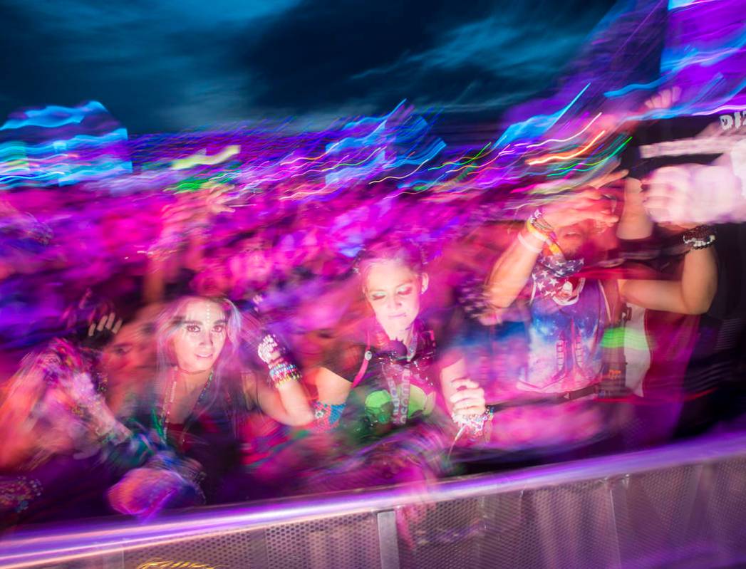 Attendees dance as Dateless performs at the Stereobloom stage during the third day of the Elect ...