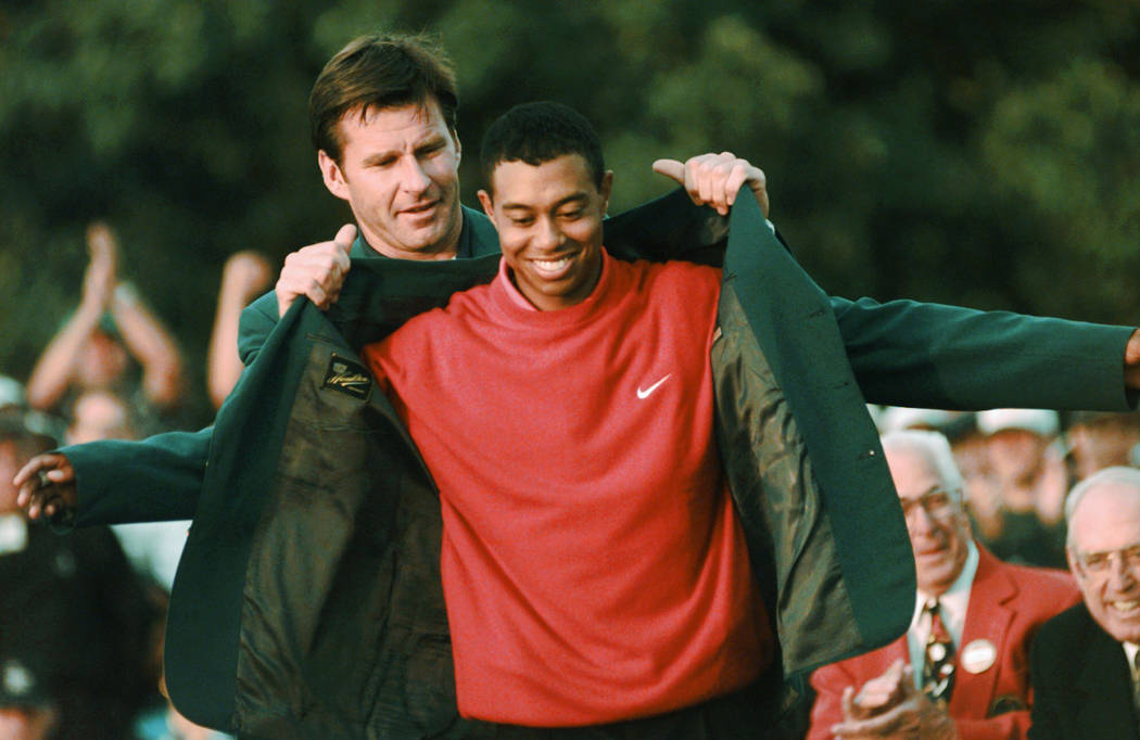 FILE - In this April 13, 1997, file photo, Masters champion Tiger Woods receives his Green Jack ...