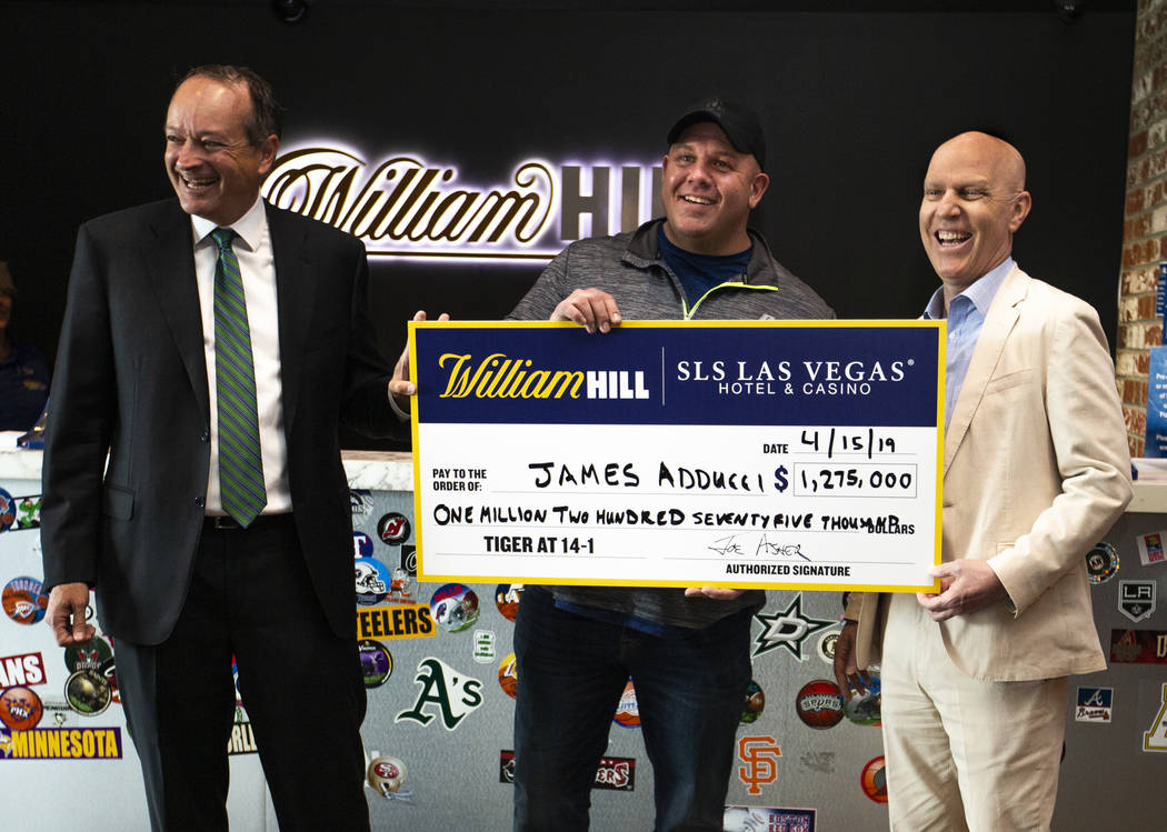 William Hill CEO Joe Asher, stands with big winner James Adducci of Wisconsin and SLS General M ...