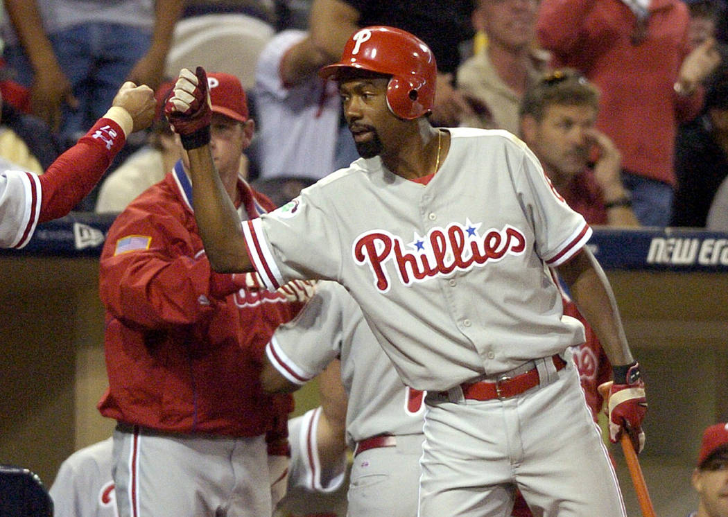 FILE - In this Aug. 5, 2004, file photo, Philadelphia Phillies' Doug Glanville congratulates a ...