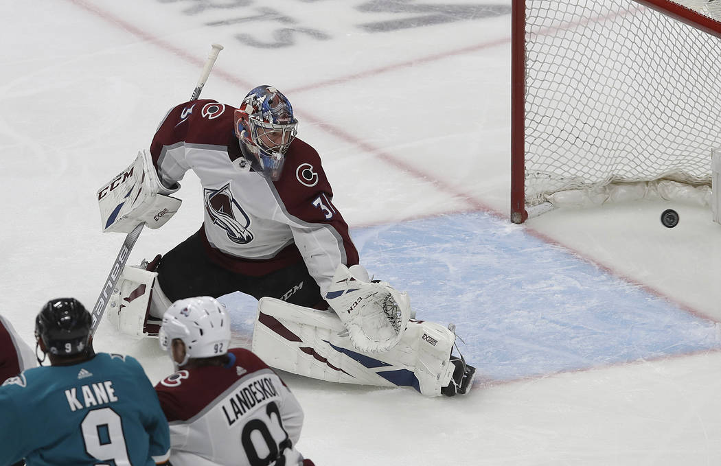 Colorado Avalanche goaltender Philipp Grubauer (31) looks back as San Jose Sharks center Joe Pa ...