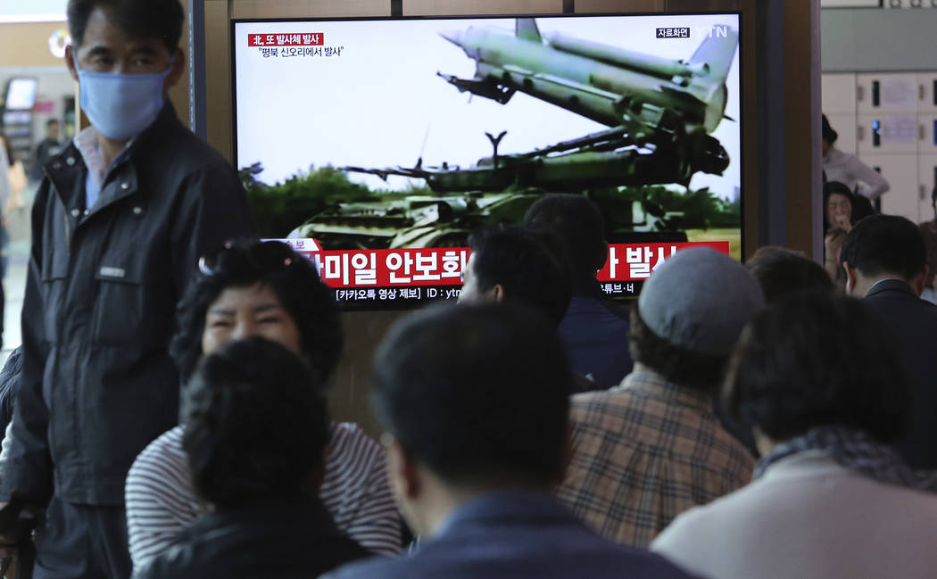 People watch a TV showing file footage of North Korea's missile during a news program at the Se ...