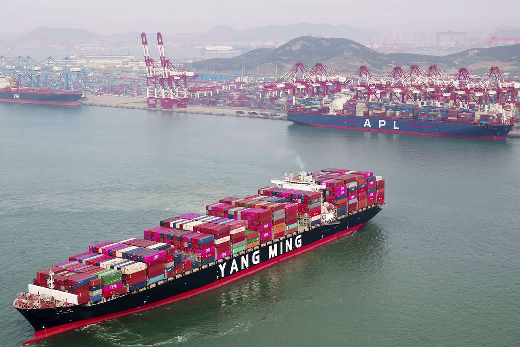 A container ship sails off the dockyard in Qingdao in eastern China's Shandong province Wednesd ...