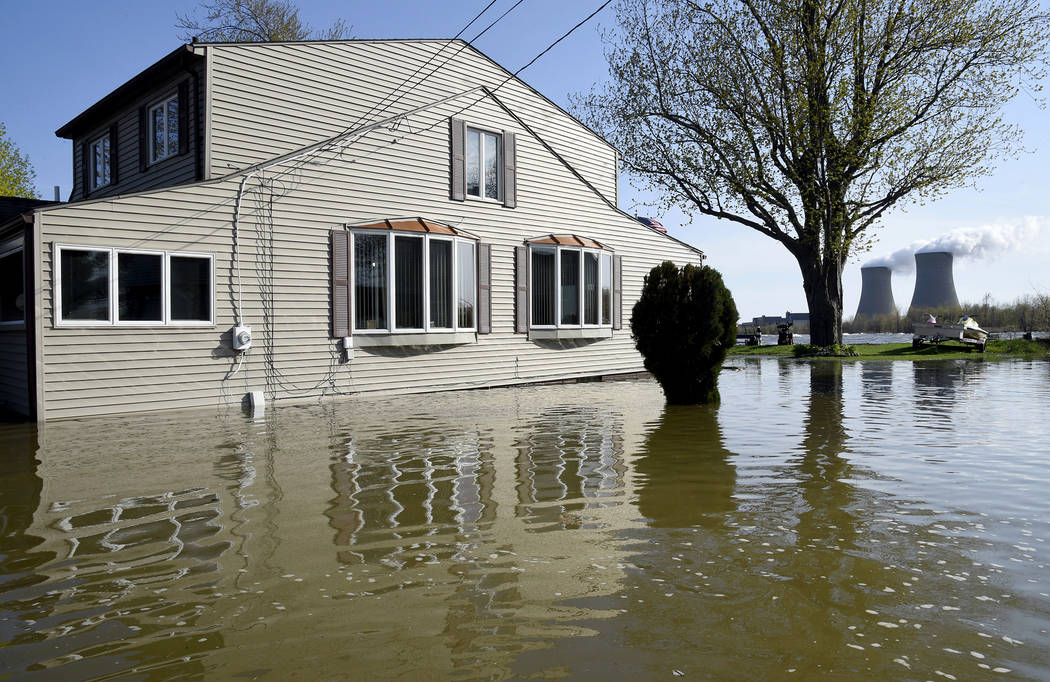 In this Wednesday, May 8, 2019 photo, a home surrounded by water on Lakeshore Dr. in the south ...