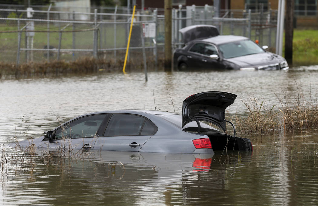 Two vehicles remain stuck in flooded Adams Street following an overnight storm Wednesday, May 8 ...