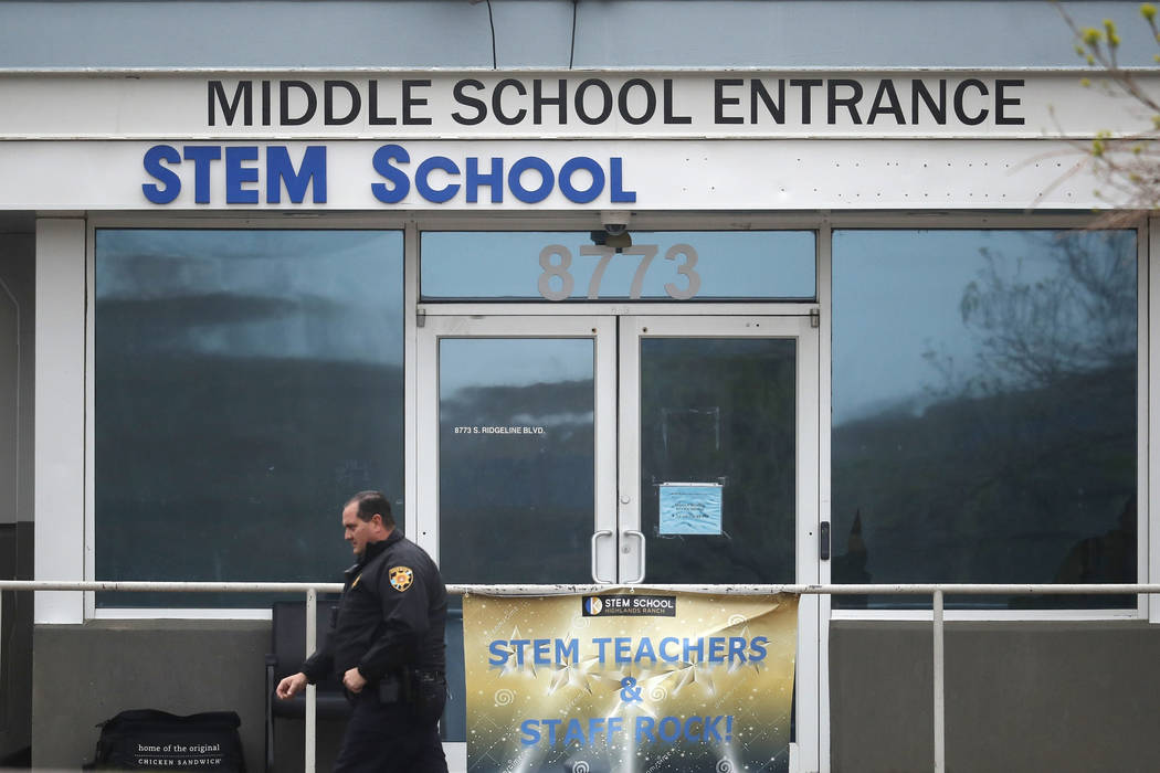 A Douglas County, Colo., Sheriffs Department deputy walks past the doors to the STEM Highlands ...