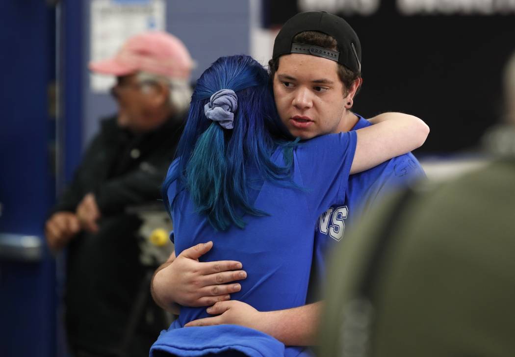 Audrey Glenn, left, hugs Andrew Schoenherr, a student at the STEM School Highlands Ranch, durin ...