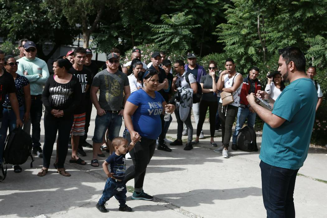 Cuban migrants are registered by Mexican immigration officials in Ciudad Juarez, Mexico, on Apr ...