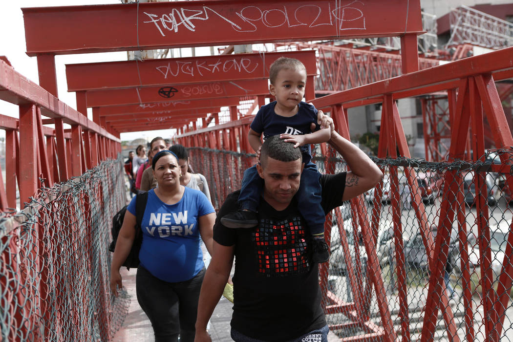 Cuban migrants are escorted in Ciudad Juarez, Mexico, by Mexican immigration officials as they ...