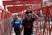 Cuban migrants are escorted in Ciudad Juarez, Mexico, by Mexican immigration officials as they ...