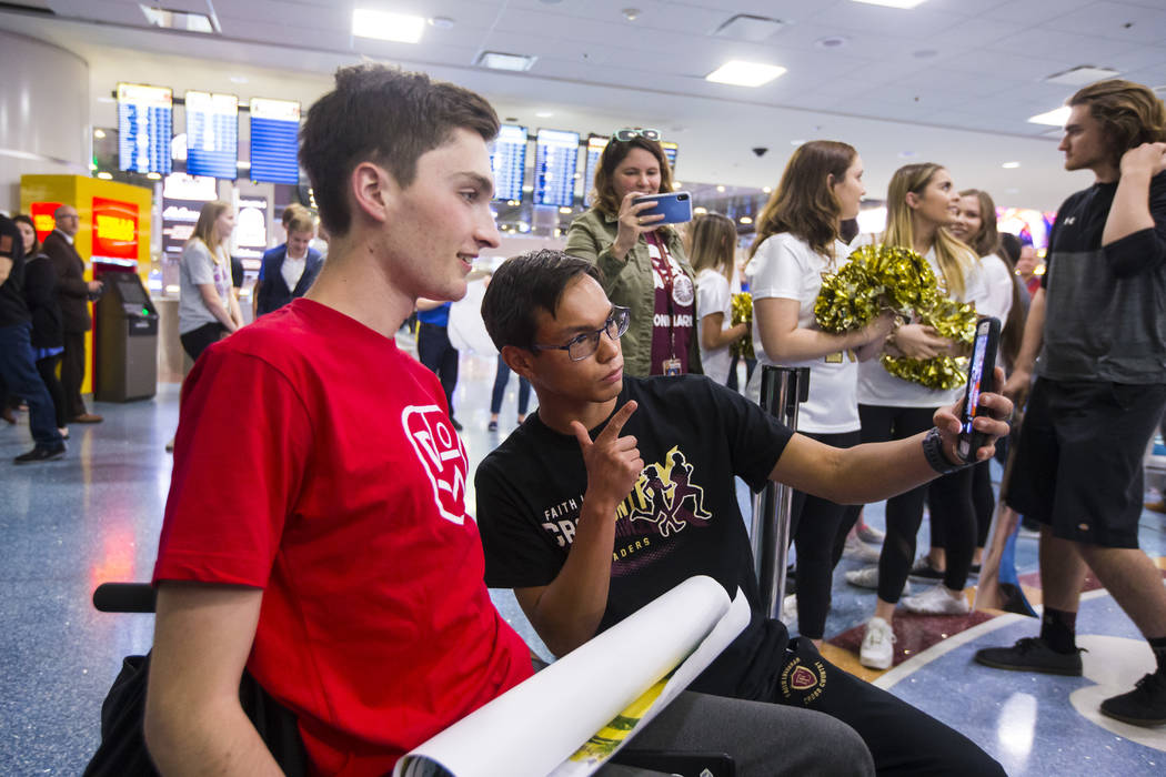 Faith Lutheran senior Mark Wilbourne, left, takes a selfie with Steve Mascella during a welcome ...