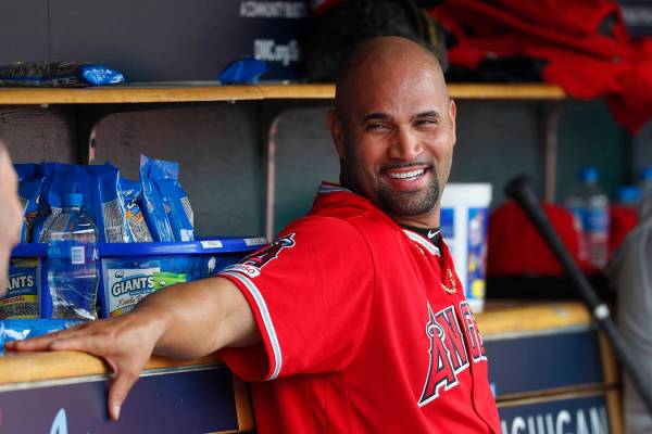 Los Angeles Angels' Albert Pujols smiles in the dugout after hitting a solo home run in the thi ...