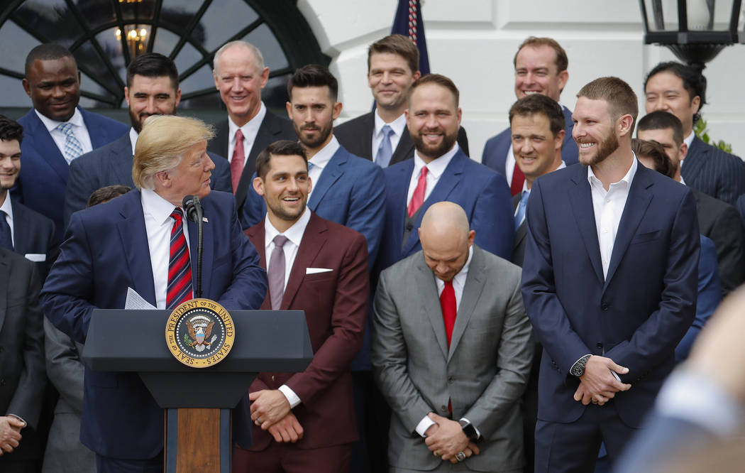 President Donald Trump, left, looks over towards pitcher Chris Sale, right, while speaking duri ...