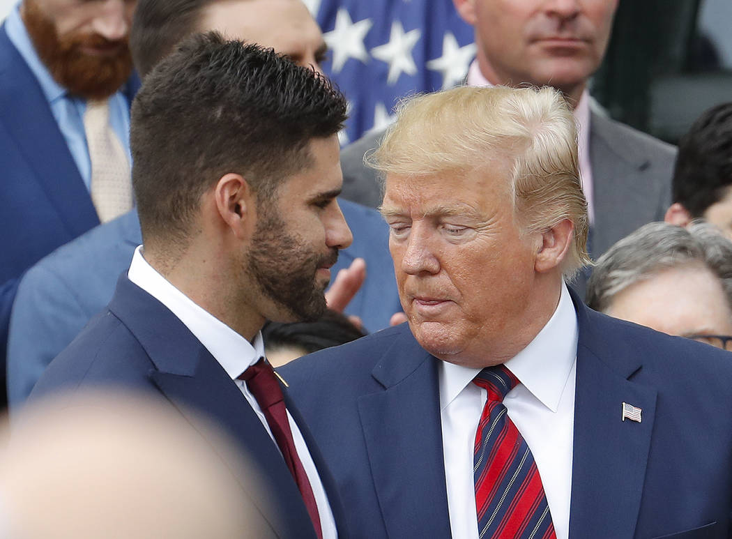 J.D. Martinez, left, walks past President Donald Trump, right, during a ceremony on the South L ...