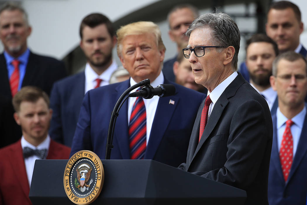 President Donald Trump listens as Red Sox owner John Henry speaks during a ceremony welcoming t ...