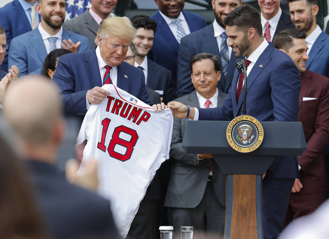 Outfielder J.D. Martinez, right, presents a team jersey to President Donald Trump, left, during ...