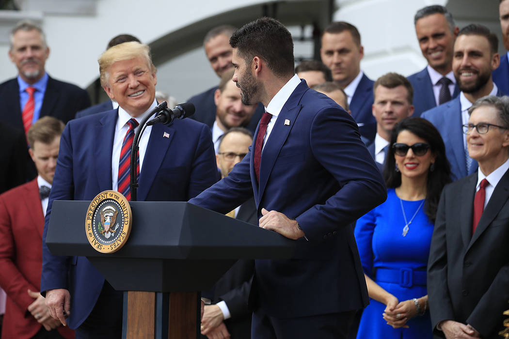 President Donald Trump reacts to Boston Red Sox outfielder J. D. Martinez's speech during a cer ...