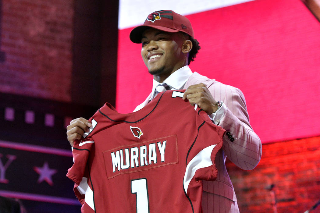 Oklahoma quarterback Kyler Murray holds his up a jersey after the Arizona Cardinals selected Mu ...