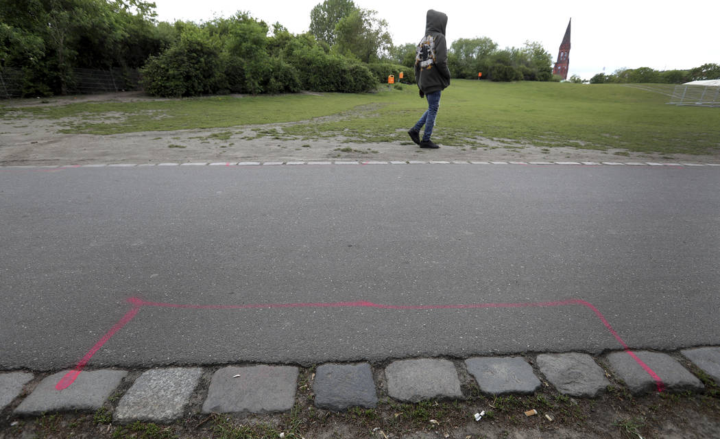 A man walks past a so called 'Drug Dealer Area' next to a traffic training course for kids at t ...