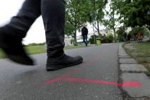 A man walks past a so called 'Drug Dealer Area' next to a traffic training course for kids at t ...