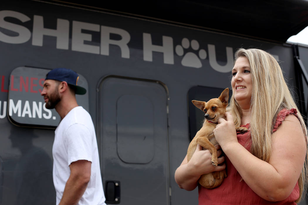 Renne Babiracki, of Oregon, holds Penny outside The Asher House RV in the parking lot of Nevada ...