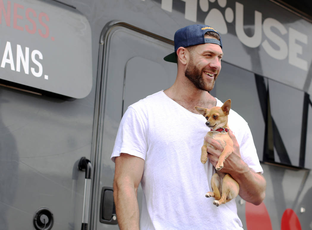 Lee Asher talks to fans while holding Penny outside The Asher House RV in the parking lot of Ne ...