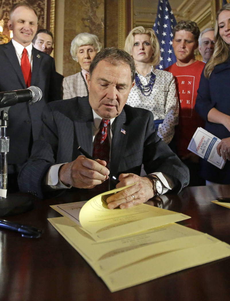 In this April 19, 2016, file photo, Utah Gov. Gary Herbert looks up during a ceremonial signing ...