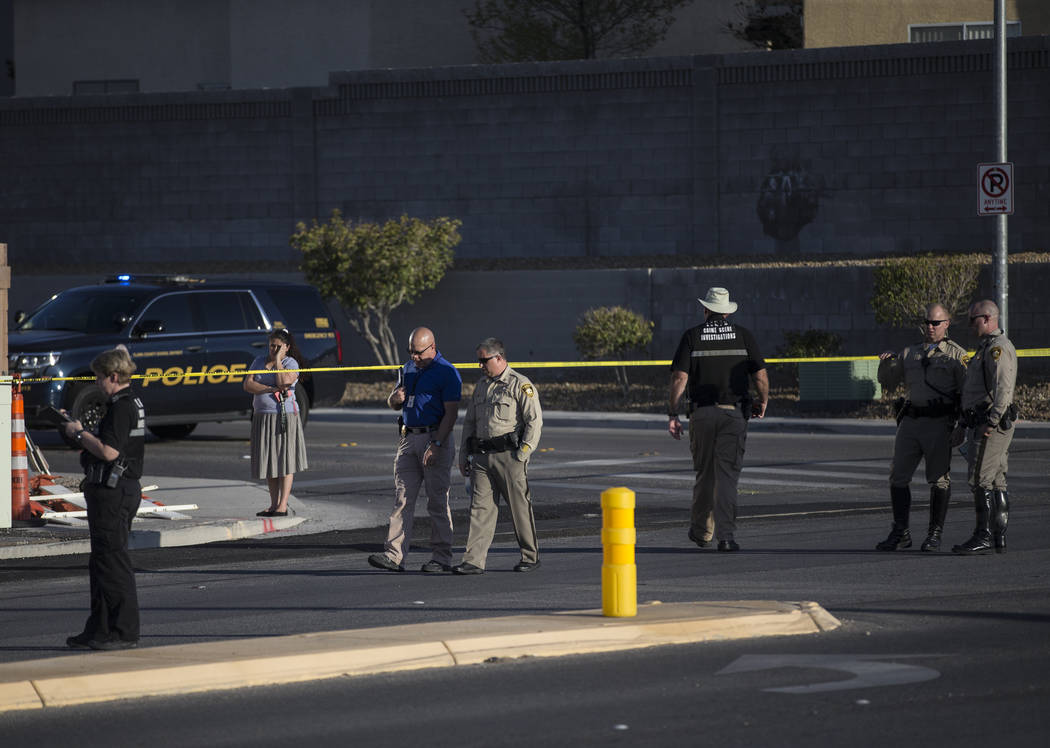 Law enforcement investigate a car accident at South Fort Apache Road and West Arby Avenue that ...