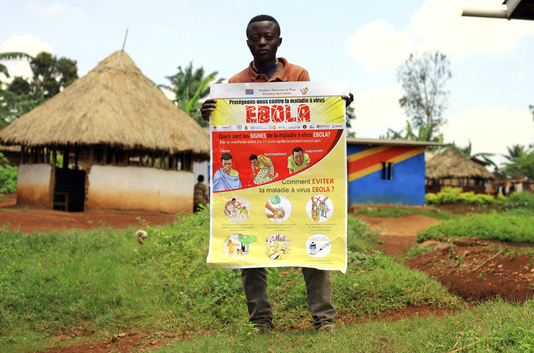 FILE - In this Wednesday, Aug 8, 2018 file photo, a man displays an Ebola information leaflet f ...
