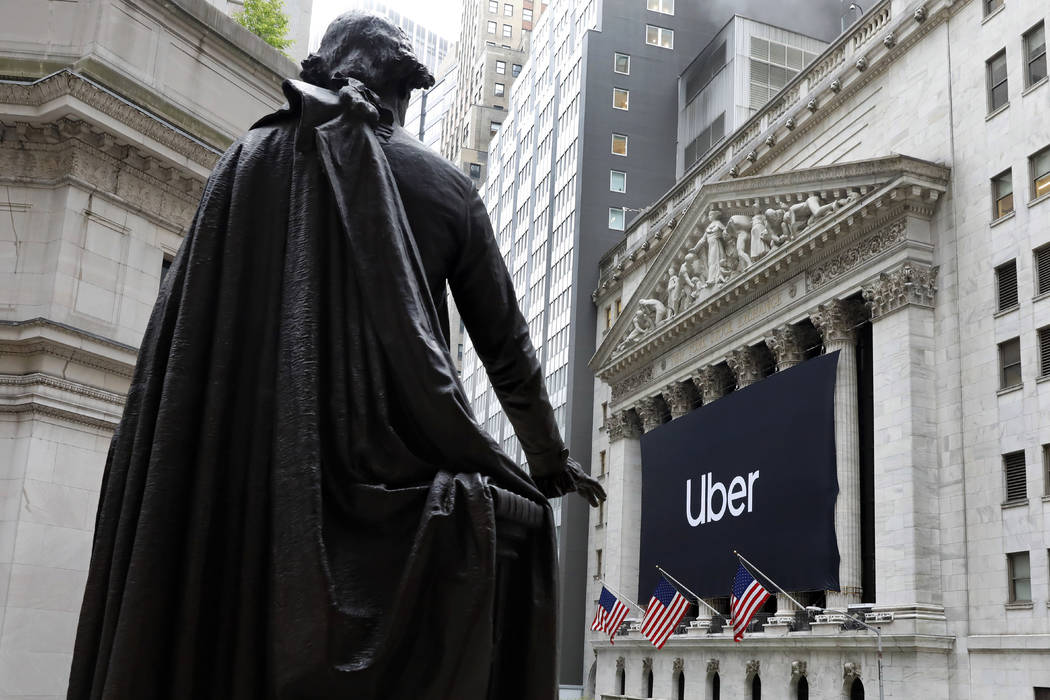 The statue of George Washington, on the steps of Federal Hall, overlooks the Uber banner hangin ...