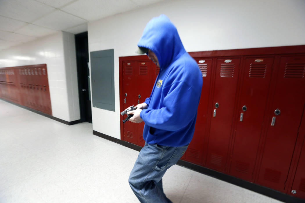 FILE - In this March 15, 2013, file photo, police detective Eric Copeland reloads a pistol with ...
