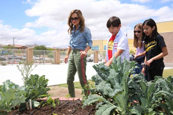 Giada De Laurentiis looks at the garden with students from left, Rhett Franquez, 11, Maddie DeA ...