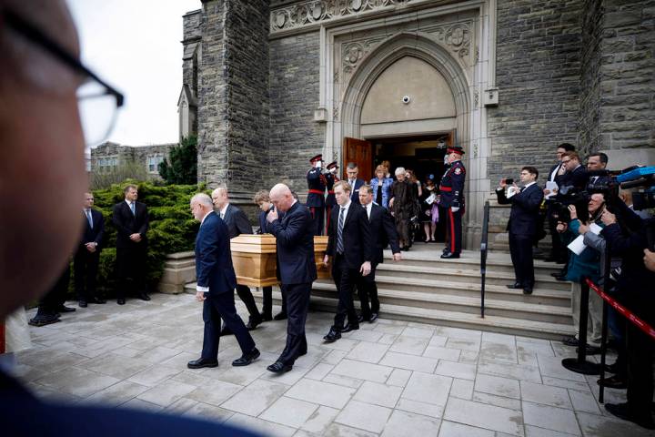 Pallbearers carry the casket of NHL legend Leonard Patrick "Red" Kelly after a funera ...