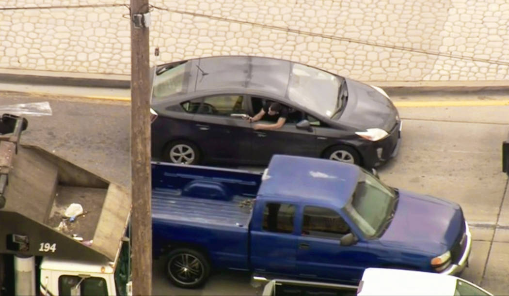 In this photo from video provided by FOX11 Los Angeles shows a man leaning out the window of a ...
