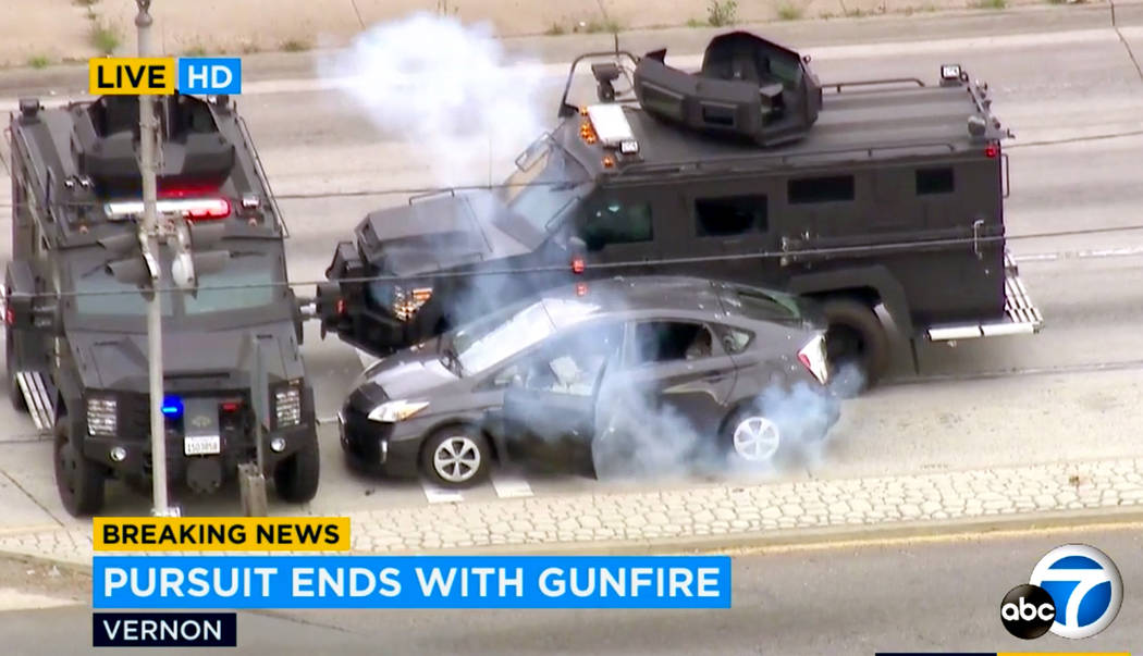 In this photo taken from video provided by KABC-TV, armored police vehicles block a car and dep ...