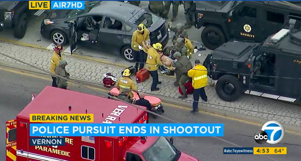 In this photo taken from video provided by KABC-TV, medics and officers tend to a wounded man a ...