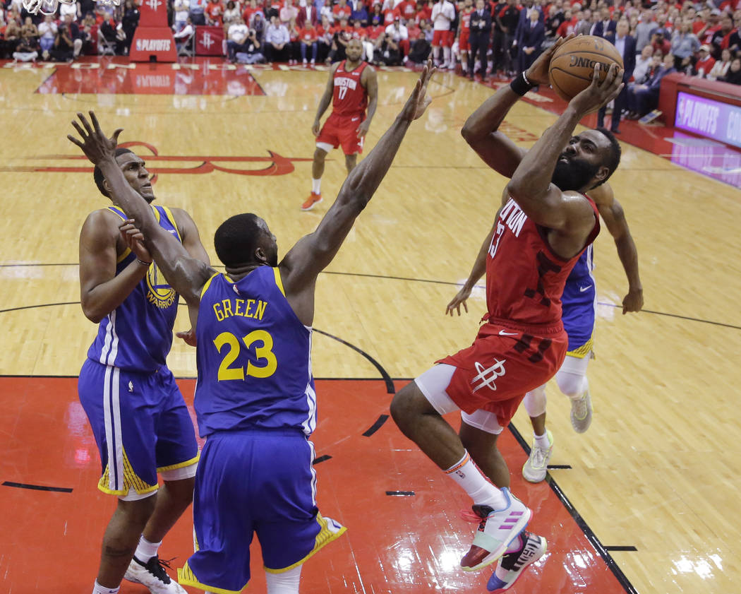 Houston Rockets guard James Harden (13) shoots over Golden State Warriors forward Draymond Gree ...